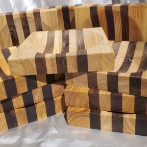 A pile of wooden blocks with black stripes on them.