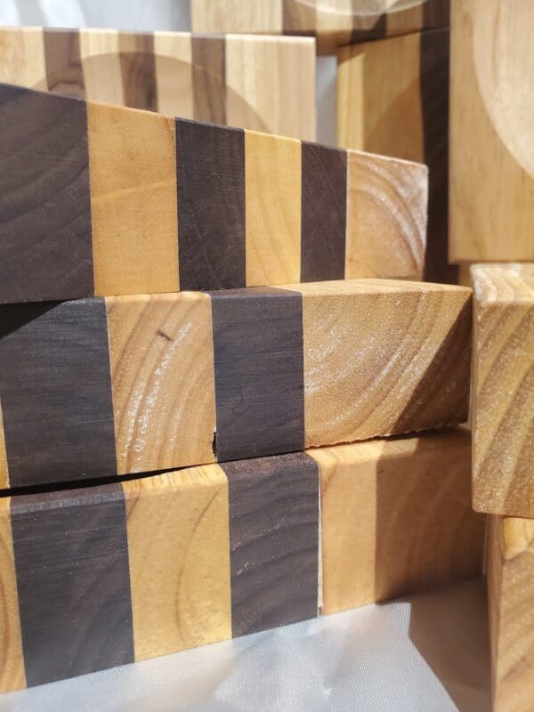A stack of wooden blocks with black and brown stripes.