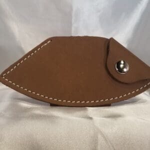 A brown leather case with a fish design.