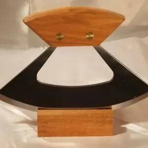 A wooden sculpture of an object with black accents.