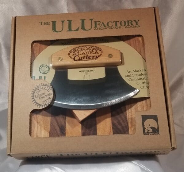 A knife in a box with the 8'' Bowl with Inupiat Ulu & Display Stand logo on it.