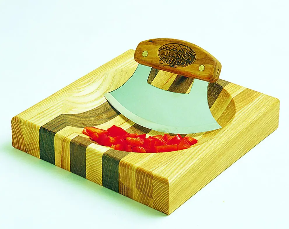 An 8'' Bowl with Inupiat Ulu & Display Stand with peppers on it.
