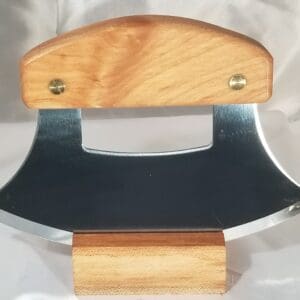 A wooden and metal knife holder on top of a table.