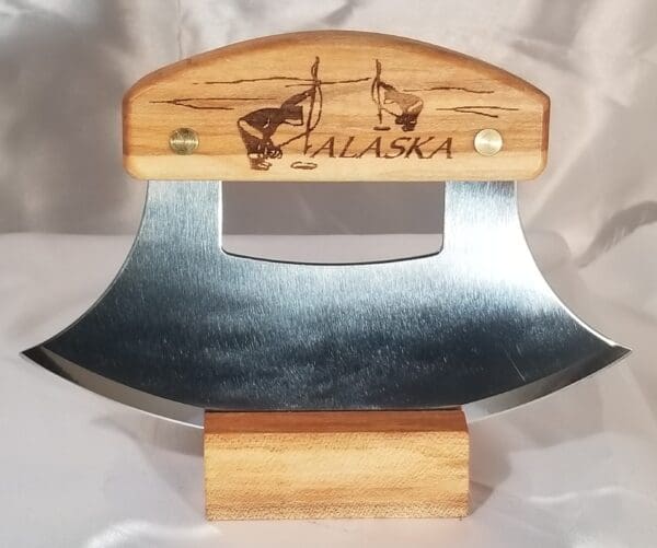 A wooden stand with an ulu knife on it.