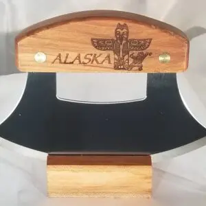 A wooden knife from the Inupiat Heritage Collection with the word alaska on it.