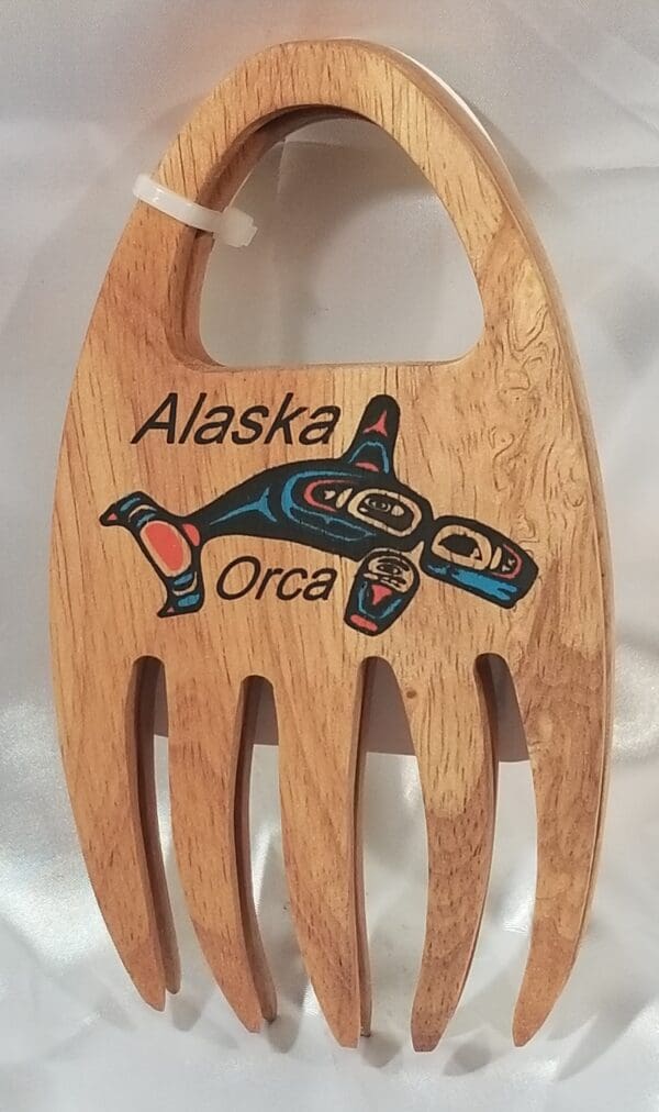 A wooden spoon with the word Alaskan Grabbers on it.