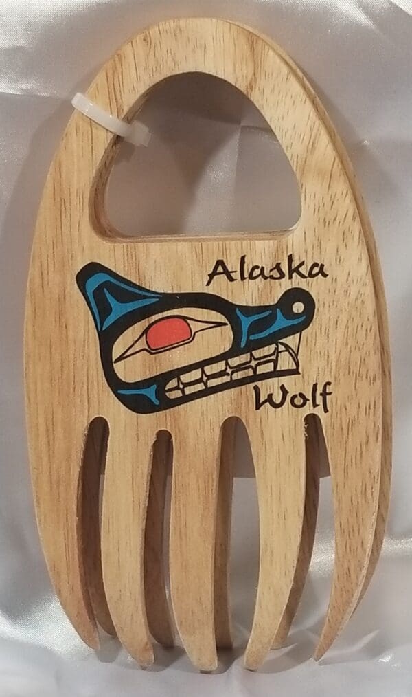 A wooden spoon with the word Alaskan Grabbers on it.