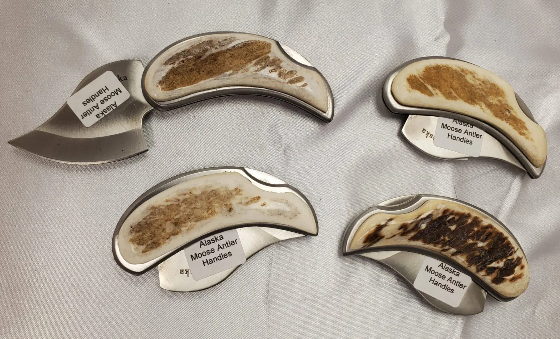 A group of four spoons with different types of food on them.