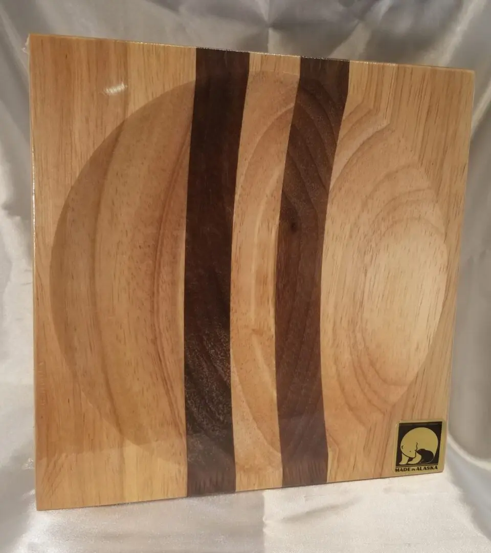 A wooden plate with three strips of wood on it.