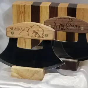 A couple of wooden knives with engraved designs on them.