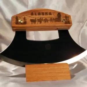 A large wooden knife with a picture of horses on it.