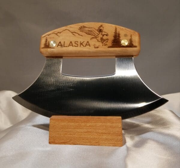 A wooden handle with an alaska design on it.