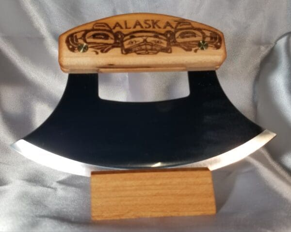An Inupiat Heritage Collection axe on a wooden stand.