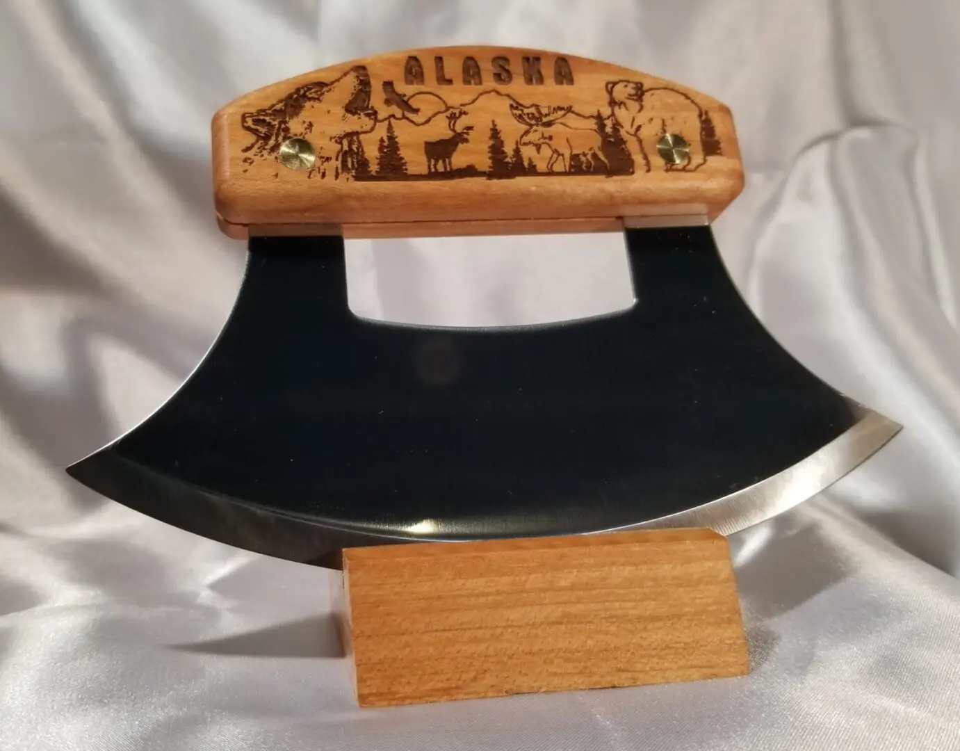 A wooden knife holder with an engraved blade.