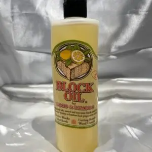 A bottle of Block Wood Oil 12oz on a white surface.
