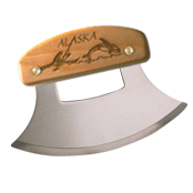 A large ulu knife with an engraved design on it.
