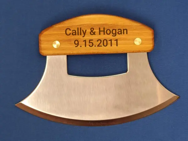 A wooden handle with an engraved name and date.