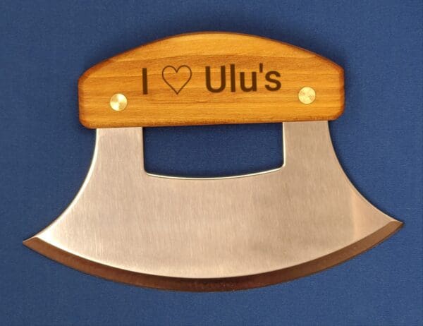 A wooden and metal ulu with the name " i love lu 's ".