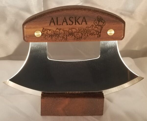 A wooden plaque with the name alaska engraved on it.