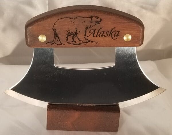 A wooden knife holder with an engraved bear on it.