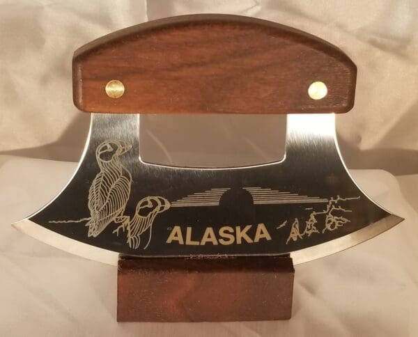 A knife from the Inupiat Puffin's and Pipeline Collection with the word alaska on it.
