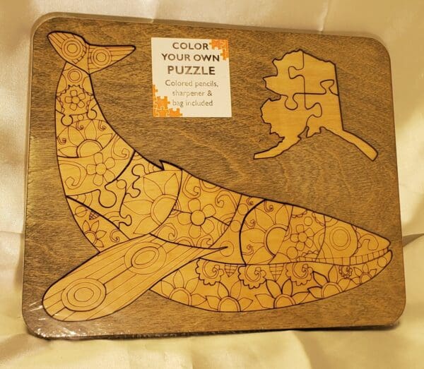 A wooden puzzle of an animal with a tree in the background.