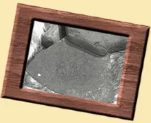 A picture frame with an image of a rock.