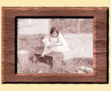 A woman sitting on the ground with her dog.