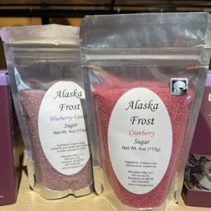 Three bags of alaska fresh cocoa powder on a shelf.