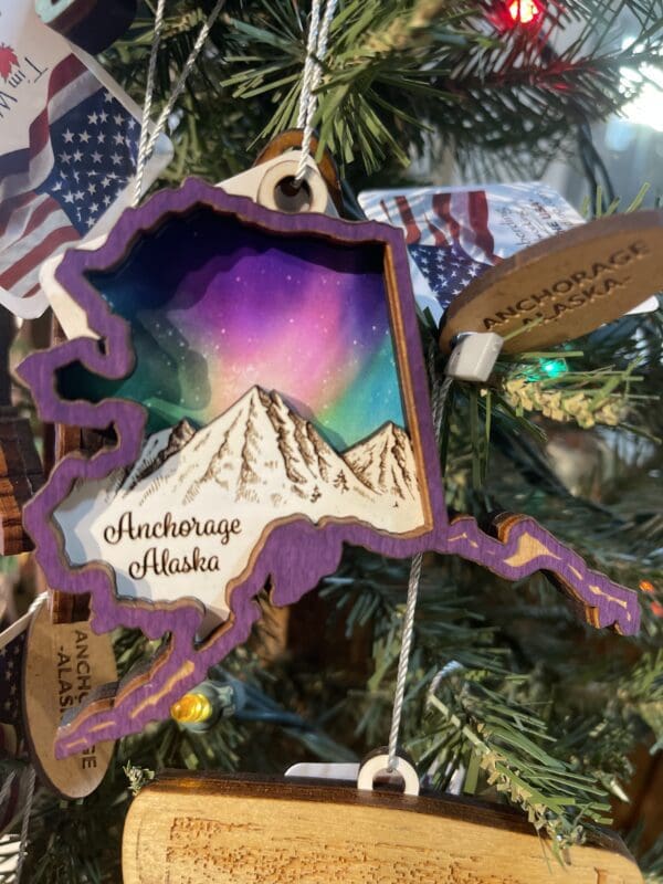 A christmas tree ornament with a map of alaska.