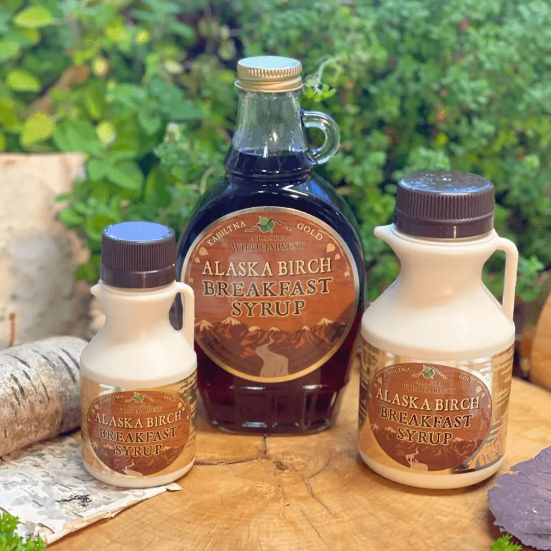 A bottle of Alaska Birch Breakfast Syrup and a bottle of maple syrup.